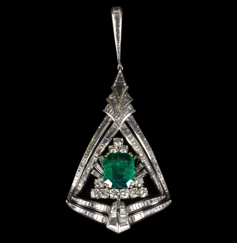 A large and impressive 18ct white gold diamond and emerald pendant.