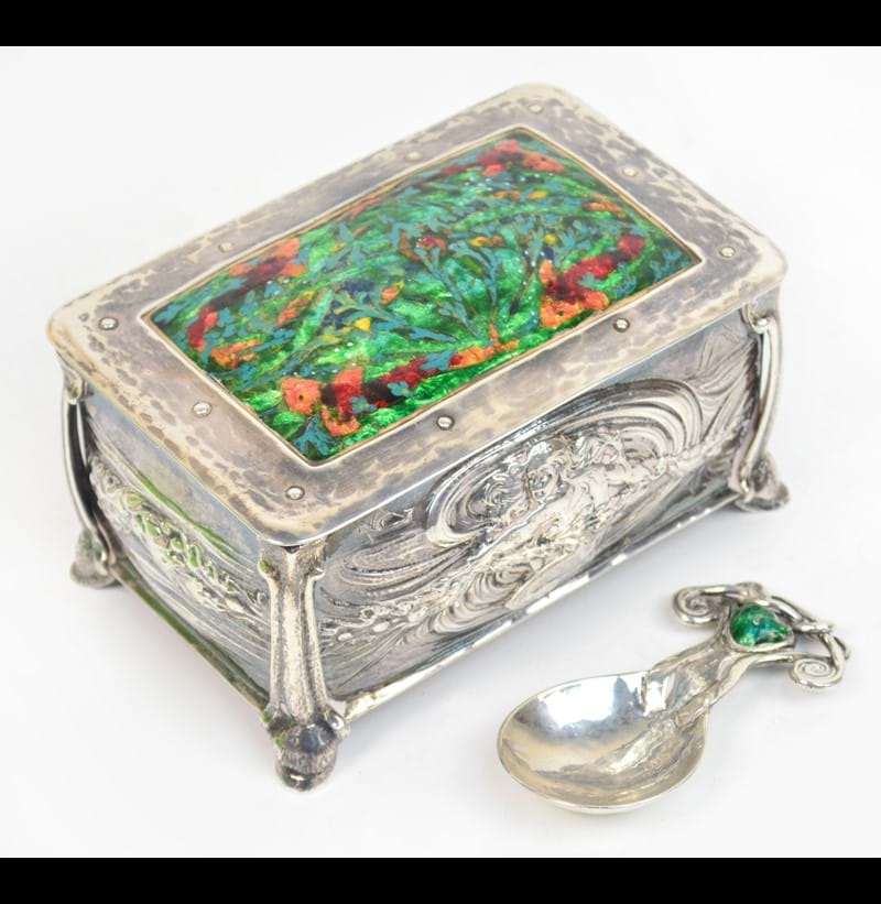 Ramsden & Carr; a fine Arts and Crafts silver and enamel decorated rounded rectangular tea canister and cover, and an enamelled caddy spoon.
