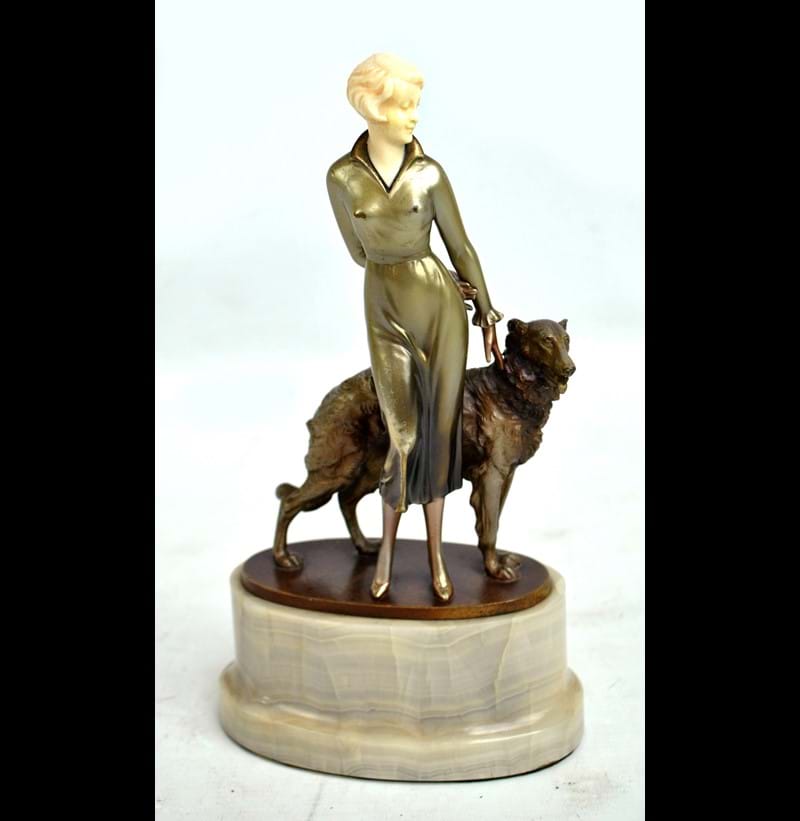 JOSEF LORENZL (AUSTRIAN 1892-1950); an Art Deco painted bronze and ivory figure of woman with a Borzoi.